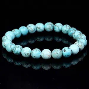 Detailed view of a turquoise beaded bracelet featuring natural stone texture and veins