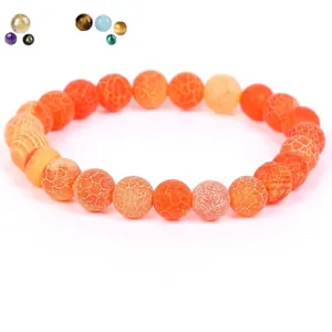 Detailed view of orange weathered stone beads featuring unique natural crackle textures