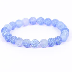 Close-up of light blue weathered stone beads with unique natural crackle textures