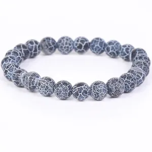 Macro detail of weathered stone beads showing intricate white crackle patterns