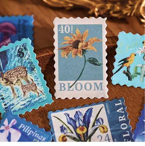 Detailed macro view of vintage floral and animal themed postage stamp stickers for scrapbooking