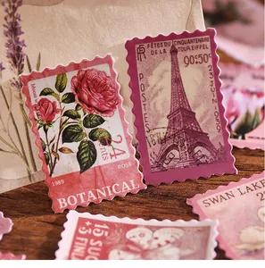 Detailed view of vintage postage stamp stickers with rose and Eiffel Tower designs