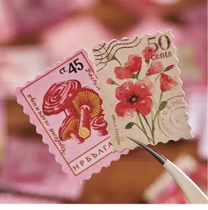 Detail view of vintage floral and mushroom stamp stickers for DIY journal decor