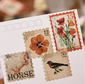 Detail view showing vintage-style floral, horse and bird stamp stickers on a white card