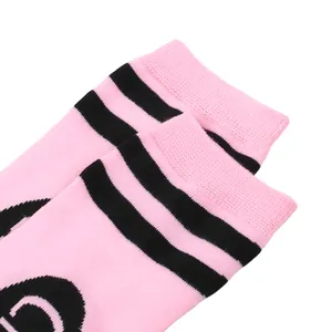 Detailed close-up of pink knee-high socks with two black stripes for costume parties