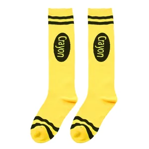 Close-up detail of yellow crayon style knee high socks with black stripes and logo.