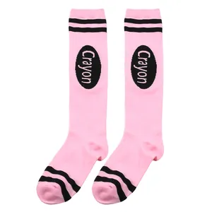 Detail of pink knee-high socks with black crayon-inspired logo and double stripes.