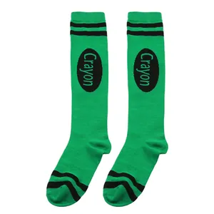 Close-up of green crayon-style knee-high socks with black stripes and text details.