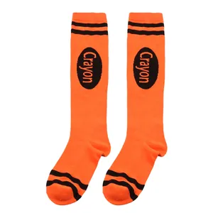 Close-up detail of vibrant orange Crayon costume knee-high socks with black stripes