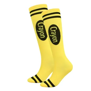 Detailed macro view of vibrant yellow knee-high socks featuring Crayon print and black stripes