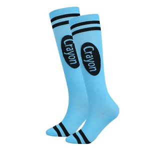 Detail view of light blue knee-high socks featuring black stripes and Crayon print design
