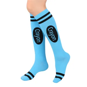 Close-up of light blue knee-high socks featuring black stripes and Crayon logo print