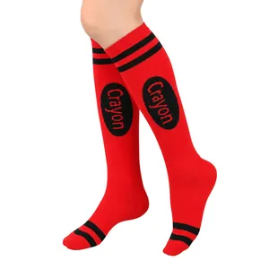 Detailed close-up view of red crayon-themed knee-high socks featuring classic black stripes