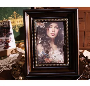Classic vintage dark brown picture frame with beaded gold trim and retro portrait display