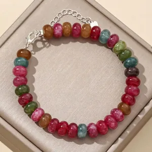 Detailed macro view of colorful 5x8mm natural stone abacus bead bracelet on display tray