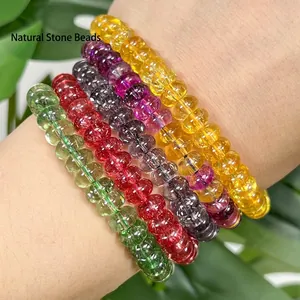 Macro view of multiple colorful 5x8mm abacus-shaped crystal beads stacked as bracelets