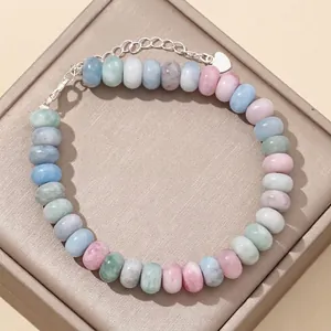 Detailed view of 5x8mm pastel morganite abacus bead bracelet with silver chain clasp.
