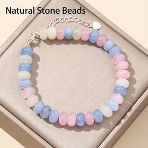 Close-up of 5x8mm abacus beads bracelet featuring natural pastel stones and silver heart charm