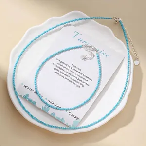 Close-up of faceted turquoise blue stone bead necklace and bracelet set on a decorative plate