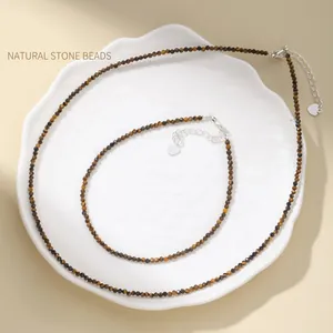 Faceted yellow tiger eye stone necklace and anklet set displayed on white ceramic plate