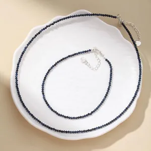 Macro view of a faceted dark blue natural stone necklace and anklet jewelry set.