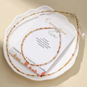 Detail of faceted carnelian and tiger eye bead necklace set on a decorative plate