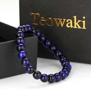 Detailed view of round blue glass beads with a cat's eye effect on a bracelet