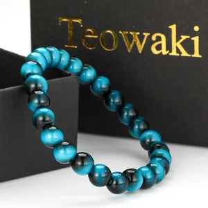 Close-up of blue and black cat's eye glass beaded bracelet in elegant black gift box