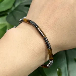 Macro detail of natural yellow tiger's eye cylindrical beads and hematite spacer bracelet