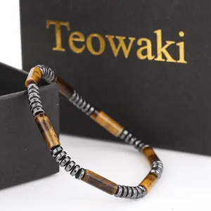 Macro view of natural tiger eye cylinder beads and hematite spacers in a bracelet