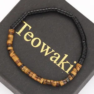 Detailed close-up of yellow tiger eye and black gallstone cylinder bead bracelet