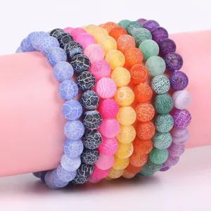 Detailed view of colorful weathered stone beaded bracelets featuring unique cracked textures