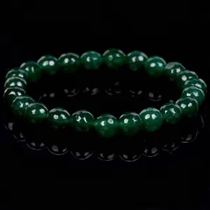 Detail view of deep green faceted crystal beads on a stretch bracelet, macro focus