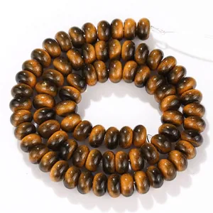 Detailed macro view of 5x8mm tiger eye glass abacus beads with a glossy polished finish
