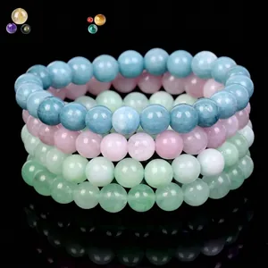 Stacked natural crystal bead bracelets in aquamarine, rose quartz, and green chalcedony