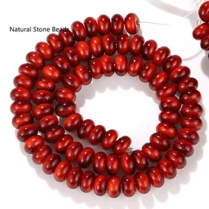 Detailed macro shot of deep red 5x8mm abacus-shaped glass beads for DIY jewelry crafts