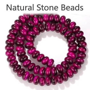 Close-up of vibrant 5x8mm magenta tiger eye glass abacus beads for DIY jewelry making.