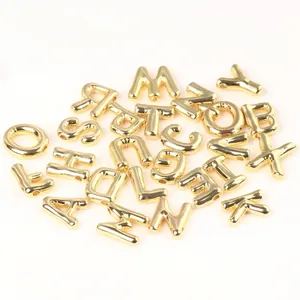 Detail view of 20mm shiny gold copper alphabet letter beads for DIY jewelry