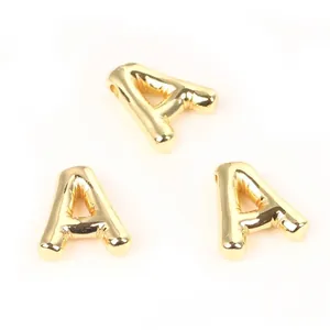 Detailed close-up of 20mm gold puffy copper letter A beads for DIY jewelry design