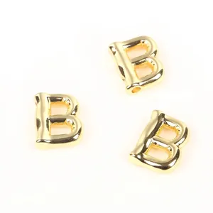 Detailed macro view of 20mm gold-plated copper balloon letter B beads for DIY jewelry