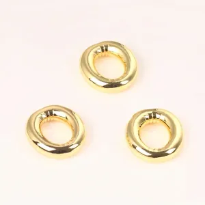 Detailed view of three 20mm shiny gold copper round beads for DIY jewelry making