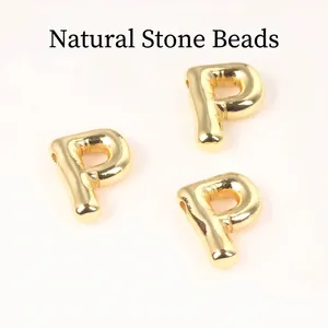 Detailed macro view of 20mm shiny golden copper letter P charms for DIY jewelry making
