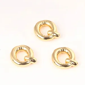 Detailed view of three 20mm gold copper letter Q beads for DIY jewelry making.