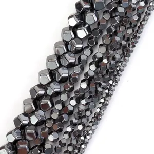 Macro detail of faceted natural hematite beads showing metallic sheen and various sizes
