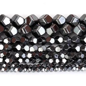 Macro view of faceted natural hematite beads in various sizes for jewelry making
