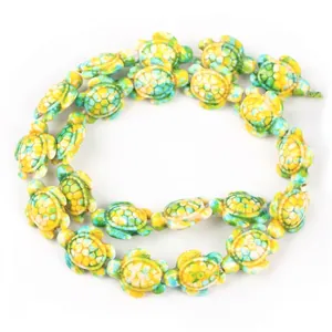 Macro detail of synthetic turquoise turtle beads in green and yellow for DIY jewelry