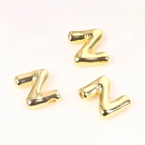 Macro detail of high-quality polished golden copper alphabet letter Z beads for DIY