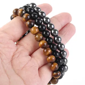 Set di tre braccialetti di perle con occhio di tigre, ossidiana e ematite.