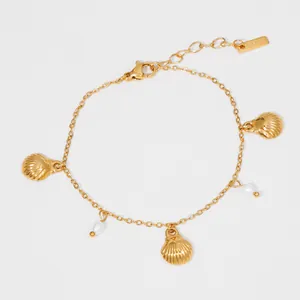 Gold stainless steel ocean themed bracelet featuring delicate shell and pearl charms