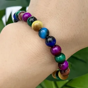 Close-up macro detail of colorful cat-eye glass beads on a stylish unisex bracelet